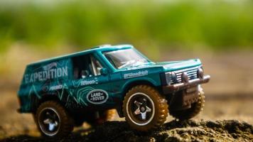 South Minahasa, Indonesia  February 2023, toy car on green grass photo