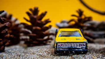 Minahasa, Indonesia  December 2022, the toy car among the pine cones photo