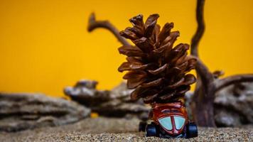 toy car hauling pinecones on an orange background photo