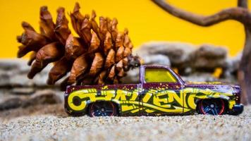 toy car hauling pinecones on an orange background photo