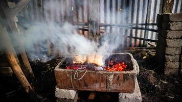 pork being grilled on coals photo