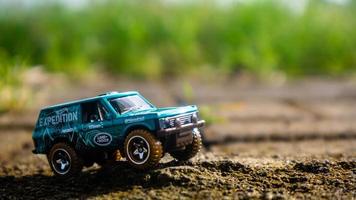 South Minahasa, Indonesia  February 2023, toy car on green grass photo