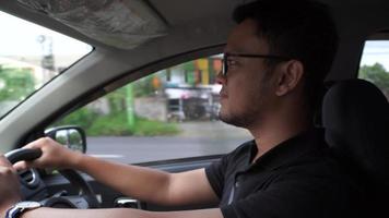 Young man driving the car with happy expression video