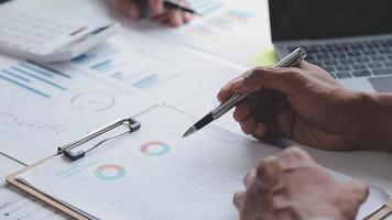 Financial analysts analyze business financial reports on a digital tablet planning investment project during a discussion at a meeting of corporate showing the results of their successful teamwork. video