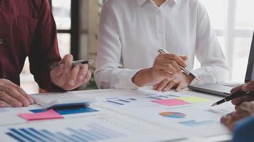 Financial analysts analyze business financial reports on a digital tablet planning investment project during a discussion at a meeting of corporate showing the results of their successful teamwork. video