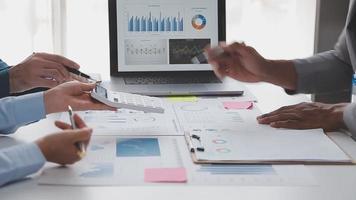Financial analysts analyze business financial reports on a digital tablet planning investment project during a discussion at a meeting of corporate showing the results of their successful teamwork. video