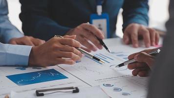 Financial analysts analyze business financial reports on a digital tablet planning investment project during a discussion at a meeting of corporate showing the results of their successful teamwork. video
