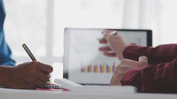 Financial analysts analyze business financial reports on a digital tablet planning investment project during a discussion at a meeting of corporate showing the results of their successful teamwork. video