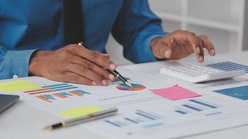 Financial analysts analyze business financial reports on a digital tablet planning investment project during a discussion at a meeting of corporate showing the results of their successful teamwork. video