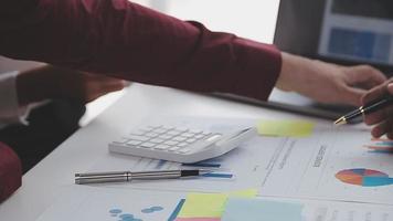 Financial analysts analyze business financial reports on a digital tablet planning investment project during a discussion at a meeting of corporate showing the results of their successful teamwork. video
