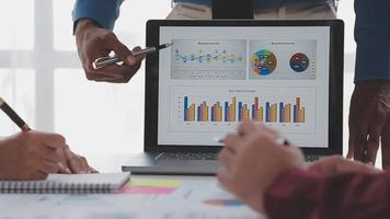 Financial analysts analyze business financial reports on a digital tablet planning investment project during a discussion at a meeting of corporate showing the results of their successful teamwork. video