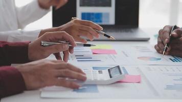 Financial analysts analyze business financial reports on a digital tablet planning investment project during a discussion at a meeting of corporate showing the results of their successful teamwork. video