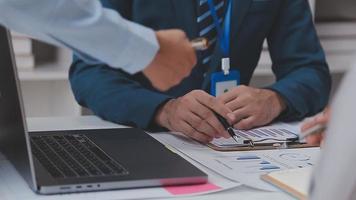 Financial analysts analyze business financial reports on a digital tablet planning investment project during a discussion at a meeting of corporate showing the results of their successful teamwork. video