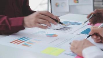 Financial analysts analyze business financial reports on a digital tablet planning investment project during a discussion at a meeting of corporate showing the results of their successful teamwork. video