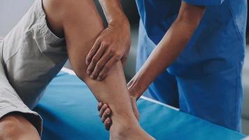 Physical therapists work with patients in close-up clinics. The concept of rehabilitation of physical health, the doctor gives advice to the patient. Ankle problems and muscle injuries video