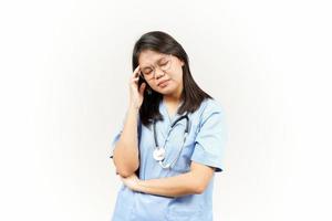 Suffering Headache Of Asian Young Doctor Isolated On White Background photo