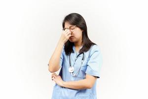 Suffering Headache Of Asian Young Doctor Isolated On White Background photo