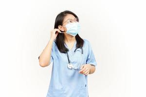 Wearing Medical Mask for Preventing Corona Virus Of Asian Young Doctor Isolated On White Background photo