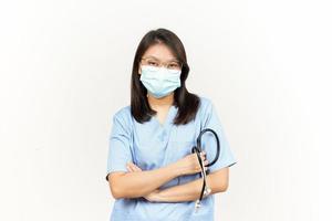 Wearing Mask And Folding Arms Of Asian Young Doctor Isolated On White Background photo