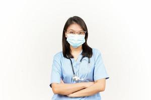 Wearing Mask And Folding Arms Of Asian Young Doctor Isolated On White Background photo