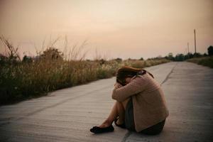 Portrait of lonely woman alone in a field. Vintage filter style.she heartbreak from love,sad girl concept on sunset vintage style photo