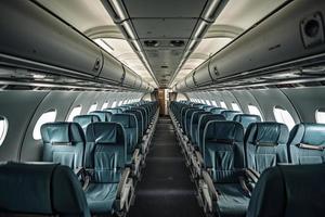 Interior of an airplane cabin with comfortable seats, overhead compartments photo