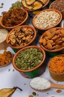 Healthy vegetarian food concept. Assortment of dried fruits, nuts and seeds on white background. Top view. photo