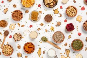 Healthy vegetarian food concept. Assortment of dried fruits, nuts and seeds on white background. Top view. photo