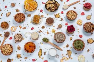 Healthy vegetarian food concept. Assortment of dried fruits, nuts and seeds on white background. Top view. photo