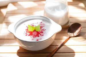 Pearl Porridge or pearl sago. Popular Indonesian desserts are commonly encountered during the month of Ramadhan. Served in a ceramic bowl with pandan leaves. photo