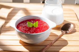 Pearl Porridge or pearl sago. Popular Indonesian desserts are commonly encountered during the month of Ramadhan. Served in a ceramic bowl with pandan leaves. photo