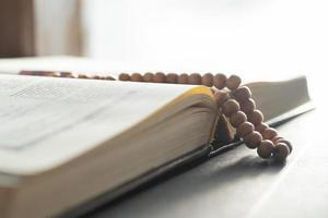 Holy book and prayer beads for Muslims. concept of the Koran and prayer beads photo