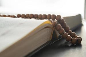 Holy book and prayer beads for Muslims. concept of the Koran and prayer beads photo