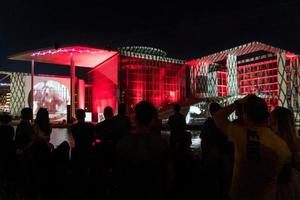 Berlin, Germany-august 8, 2022-People admire a memorial event made of lights and films projected on the government building on the river Spree at night photo