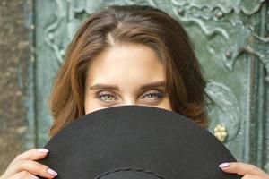 Woman hiding face with hat photo