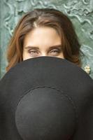 Woman hiding face with hat photo