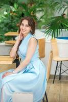 Young woman sitting at the table photo