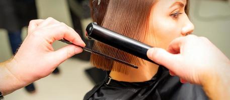 Hair stylist straightening short hair photo