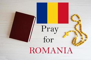 Pray for Romania. Rosary and Holy Bible background. photo