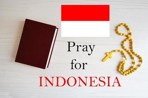 Pray for Indonesia. Rosary and Holy Bible background. photo