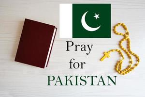 Pray for Pakistan. Rosary and Holy Bible background. photo