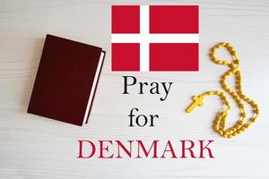 Pray for Denmark. Rosary and Holy Bible background. photo