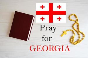 Pray for Georgia. Rosary and Holy Bible background. photo