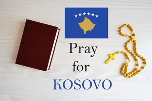 Pray for Kosovo. Rosary and Holy Bible background. photo