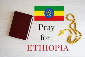 Pray for Ethiopia. Rosary and Holy Bible background. photo