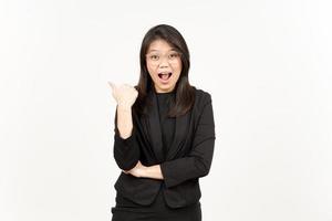 Presenting and Pointing Side Product Using Thumb Of Beautiful Asian Woman Wearing Black Blazer photo