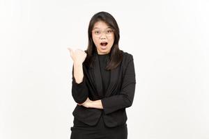 Presenting and Pointing Side Product Using Thumb Of Beautiful Asian Woman Wearing Black Blazer photo