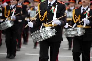 Standing soldiers beat the drums. photo