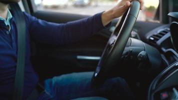 Man driving in innovative automated car using self-parking autopilot for parking on street video