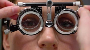 Woman at the reception of an ophthalmologist. Eye examination and selection of spectacle lenses video